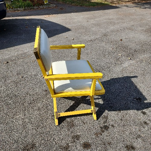 Vintage yellow campaign style chair